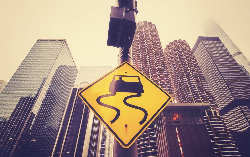 Color toned slippery road sign with Chicago skyscrapers.