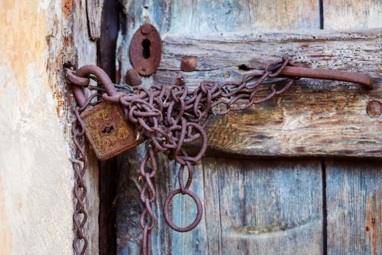 Rusty door lock and chain on an old door