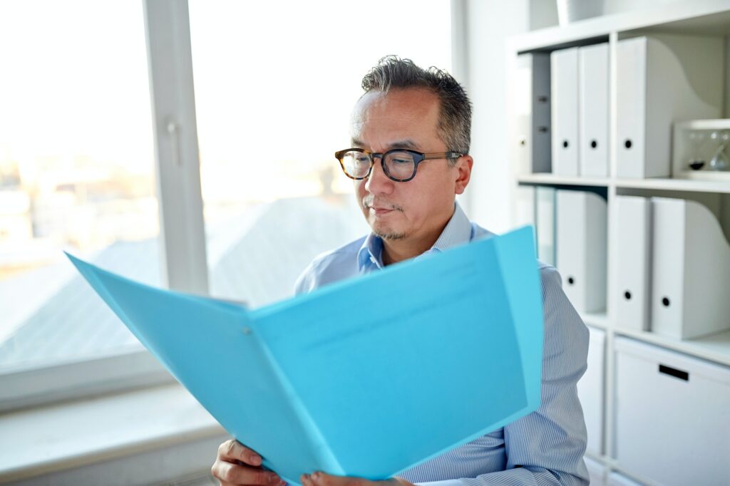 businessman with folder and papers at office